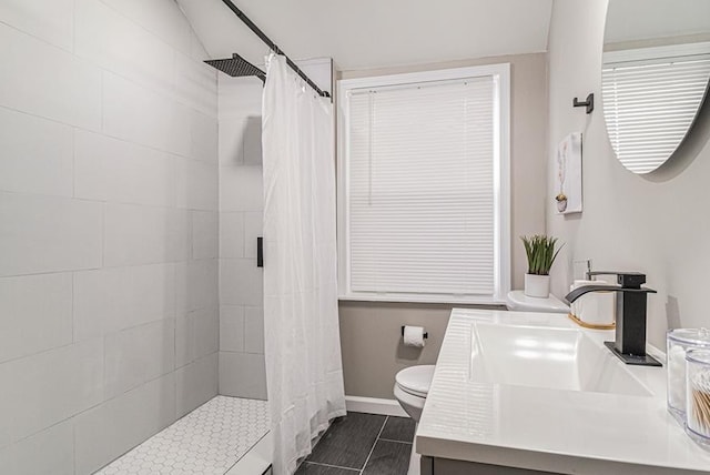 bathroom with a shower with shower curtain, vanity, toilet, and tile patterned floors