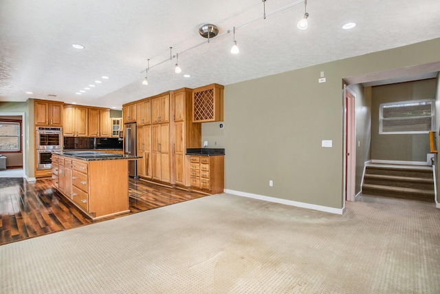 16460 15 Mile Rd, Marshall, MI 49068 - kitchen featuring stainless steel appliances, dark countertops, a kitchen island, recessed lighting, and brown cabinets