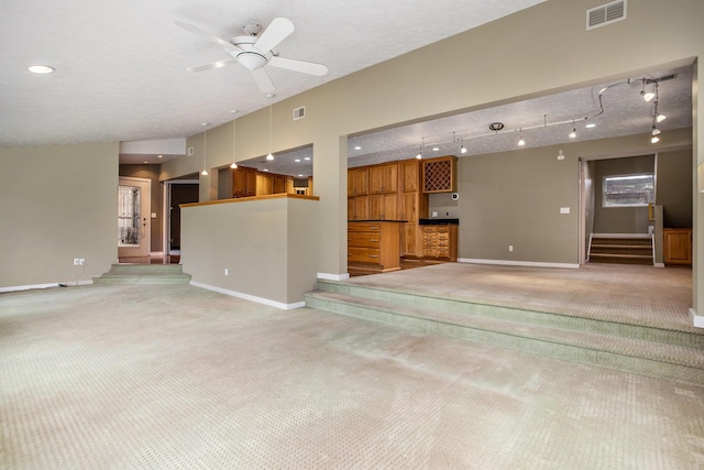 16460 15 Mile Rd, Marshall, MI 49068 - unfurnished living room with light carpet, stairway, bar, and a ceiling fan