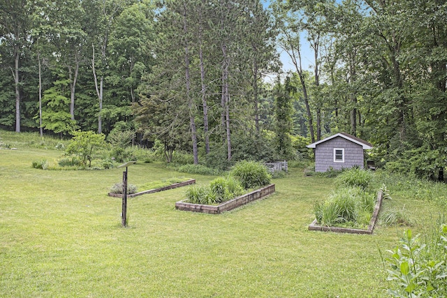 16460 15 Mile Rd, Marshall, MI 49068 - view of grassy yard featuring a garden, an outdoor structure, and a forest view