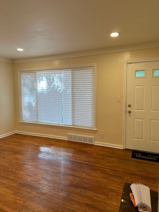 foyer entrance featuring dark hardwood / wood-style floors and ornamental molding