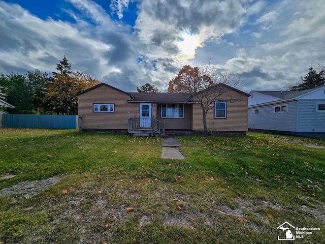 rear view of property with a lawn