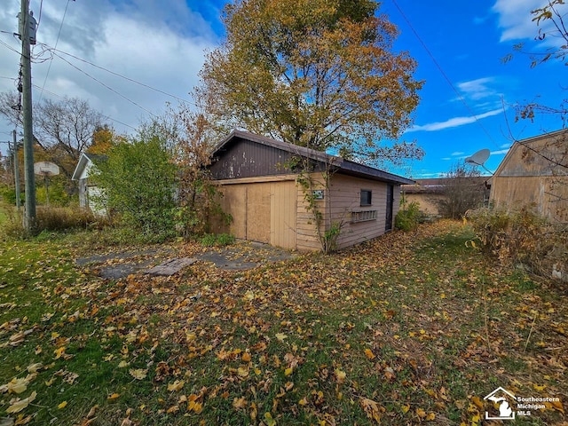 view of property exterior with an outbuilding