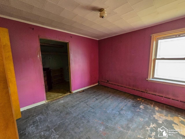 unfurnished room with a baseboard radiator and dark carpet