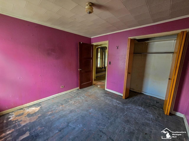 unfurnished bedroom featuring dark colored carpet and crown molding