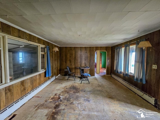 interior space featuring a baseboard radiator and wood walls