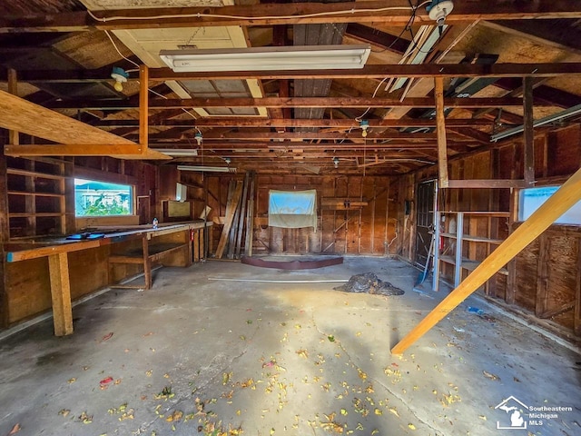 miscellaneous room featuring concrete flooring and lofted ceiling