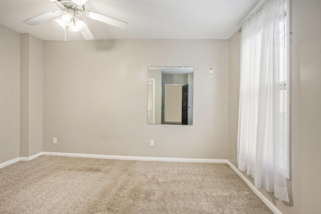 spare room with carpet and ceiling fan