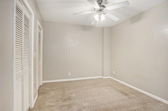 unfurnished bedroom with ceiling fan and light colored carpet