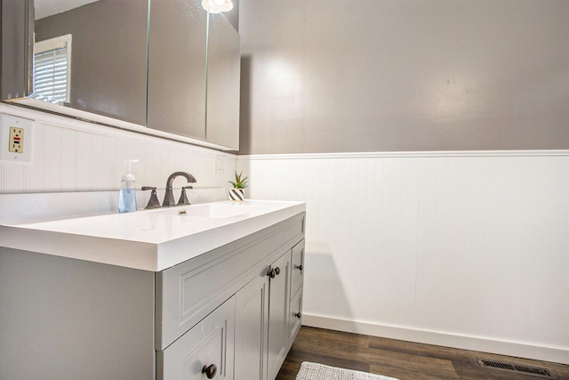 bathroom with hardwood / wood-style floors and vanity