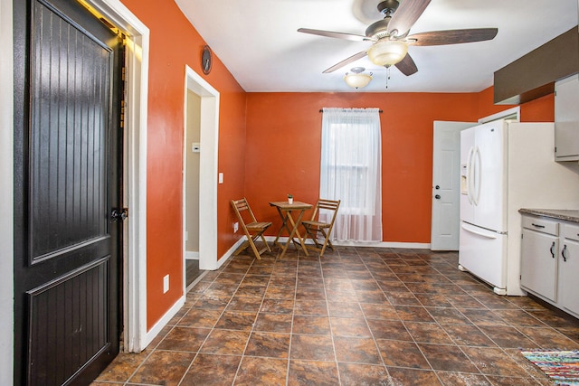 kitchen featuring ceiling fan, white cabinets, and white refrigerator with ice dispenser