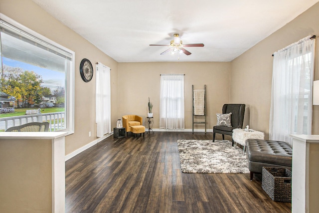 sitting room with ceiling fan and dark hardwood / wood-style flooring