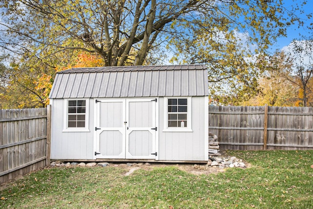 view of outbuilding featuring a yard