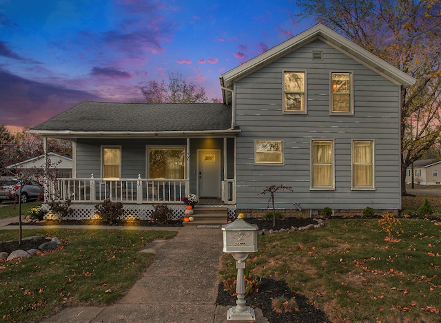 view of front of home featuring a lawn and covered porch