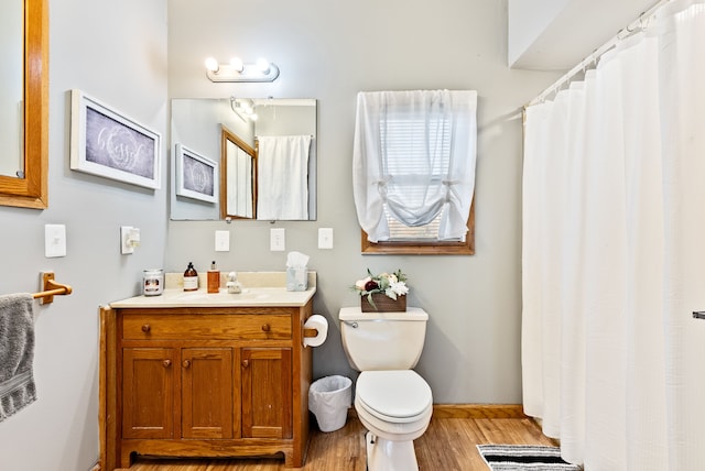 bathroom featuring vanity, wood-type flooring, and toilet