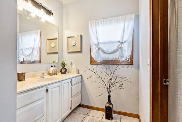 bathroom with tile patterned floors, vanity, crown molding, and a wealth of natural light