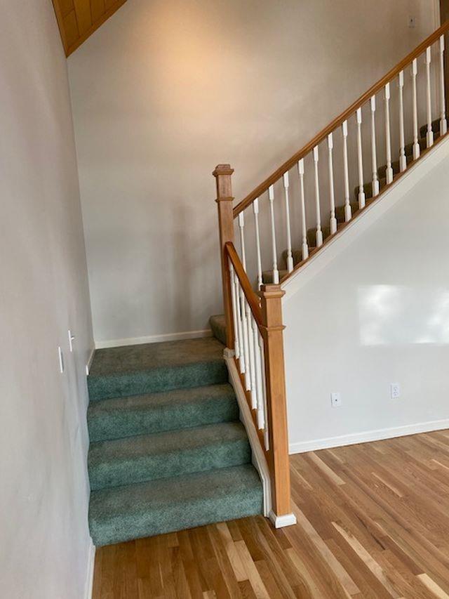 4709 State Park Hwy, Interlochen, MI 49643 - stairs with lofted ceiling and wood-type flooring