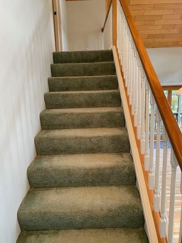 stairway with wood ceiling