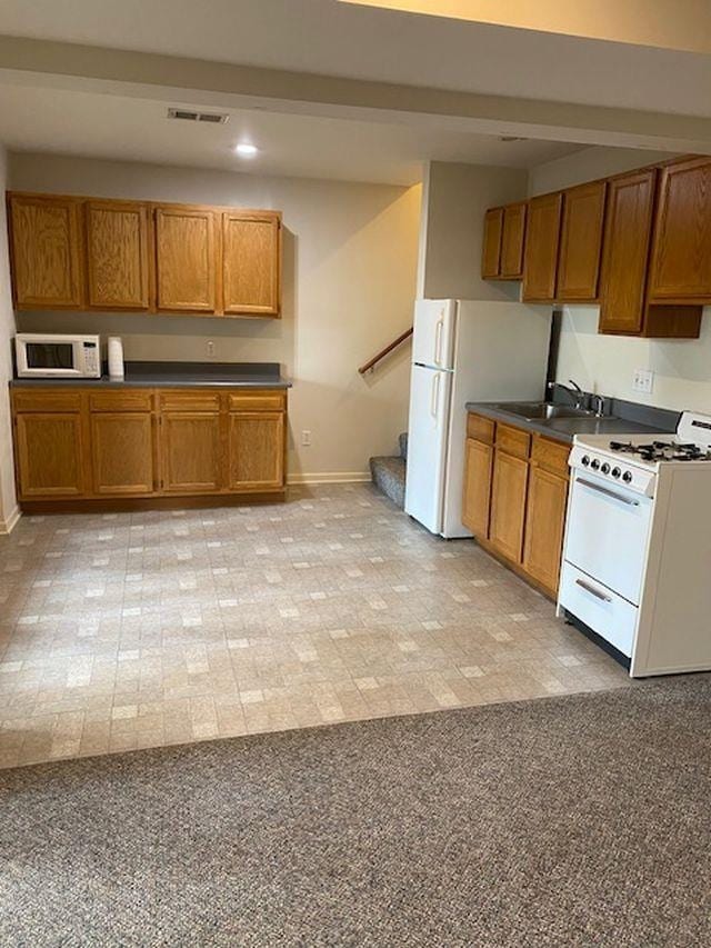 kitchen with sink and white appliances