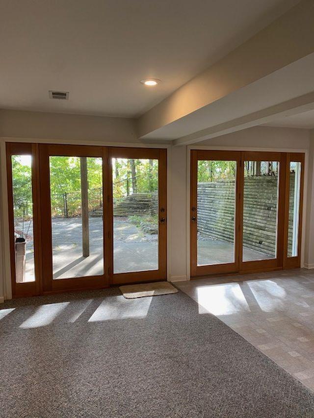 4709 State Park Hwy, Interlochen, MI 49643 - entryway with carpet and a wealth of natural light