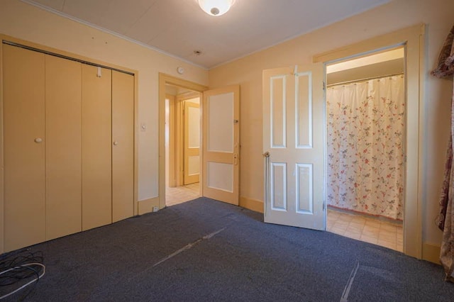 unfurnished bedroom featuring light colored carpet, a closet, and crown molding