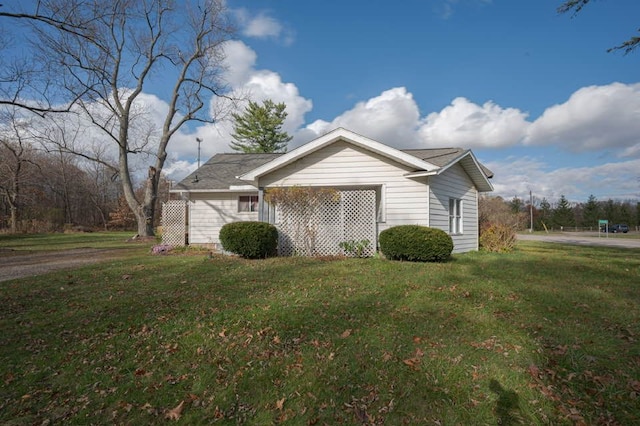 view of side of property with a yard