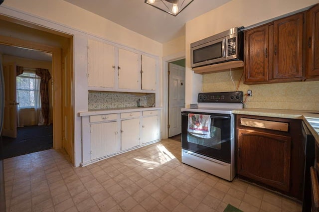 kitchen with white range with electric stovetop and decorative backsplash