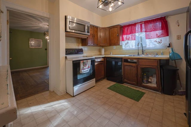 kitchen with electric range, sink, and black dishwasher