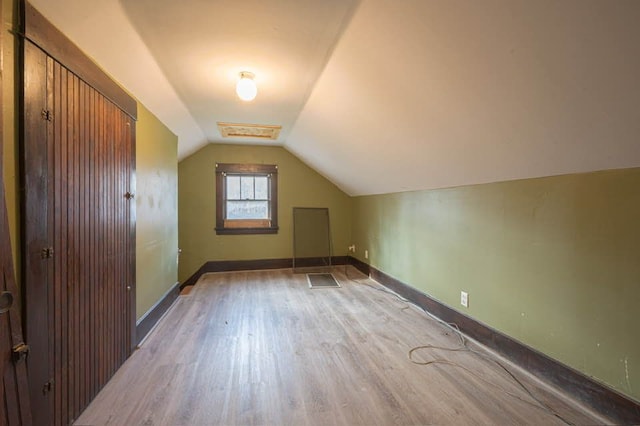 bonus room featuring light hardwood / wood-style flooring and lofted ceiling