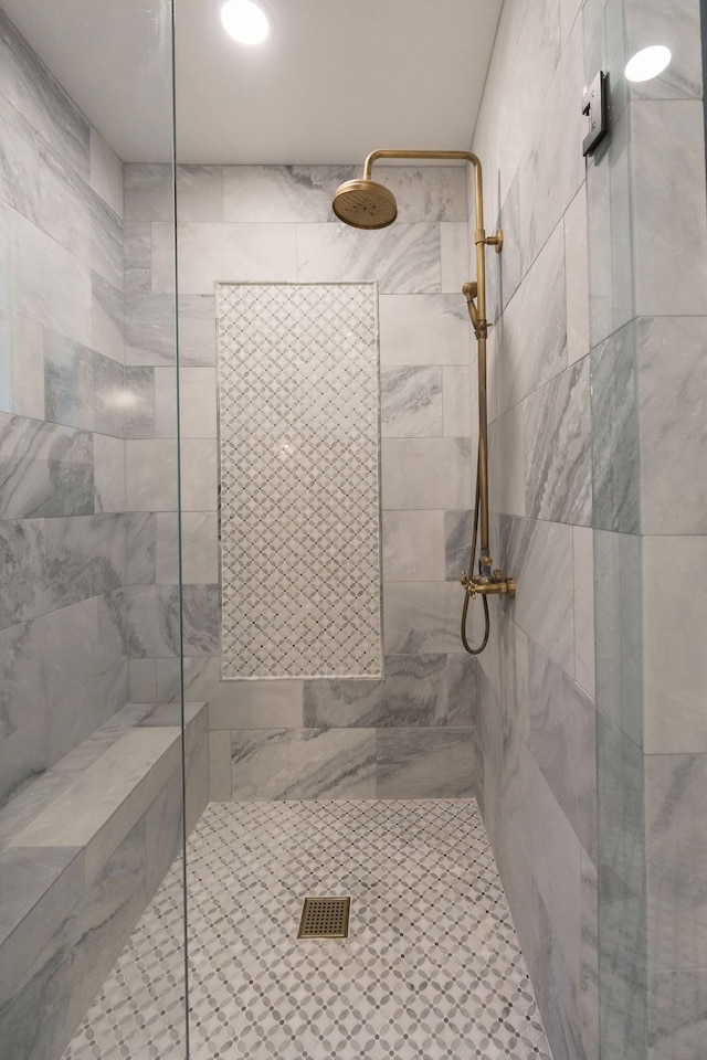 bathroom with tiled shower