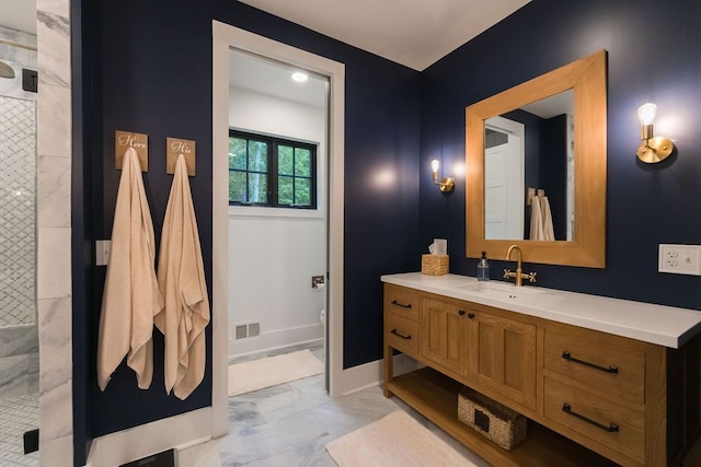 bathroom featuring a tile shower and vanity