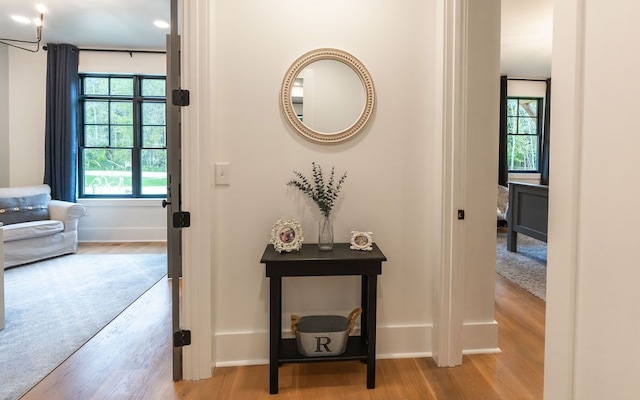 corridor with light hardwood / wood-style flooring