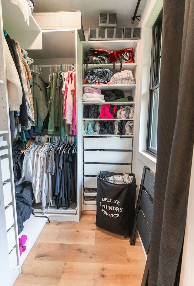 spacious closet featuring hardwood / wood-style floors