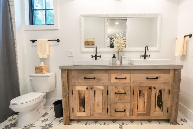 bathroom with tile patterned flooring, vanity, and toilet