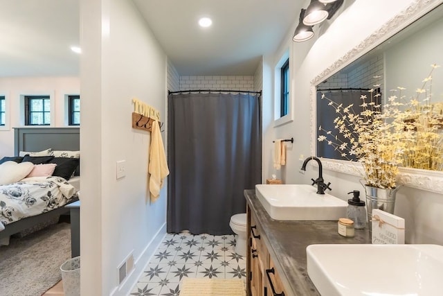 bathroom featuring tile patterned flooring, vanity, and toilet