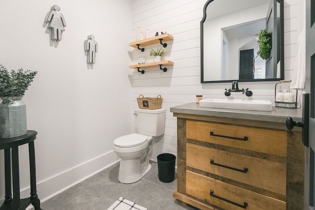 bathroom with tile patterned flooring, vanity, and toilet