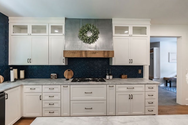 kitchen featuring light stone countertops, decorative backsplash, white cabinetry, and light hardwood / wood-style floors