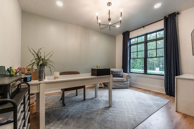 home office with hardwood / wood-style flooring and a chandelier