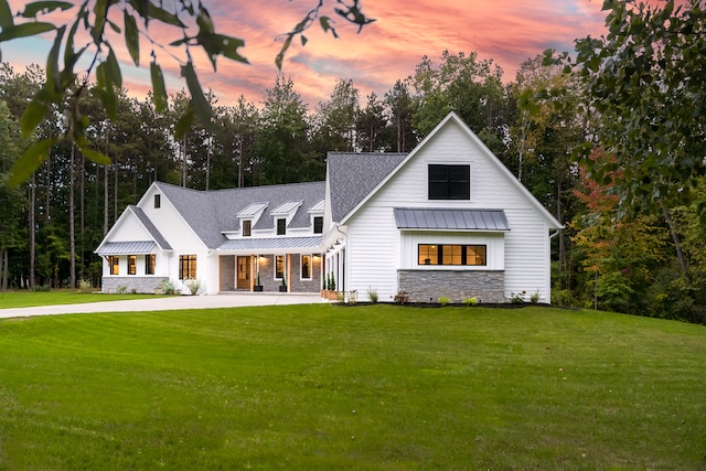 modern farmhouse style home with a yard