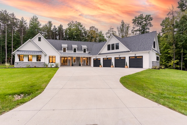 modern farmhouse style home with a lawn