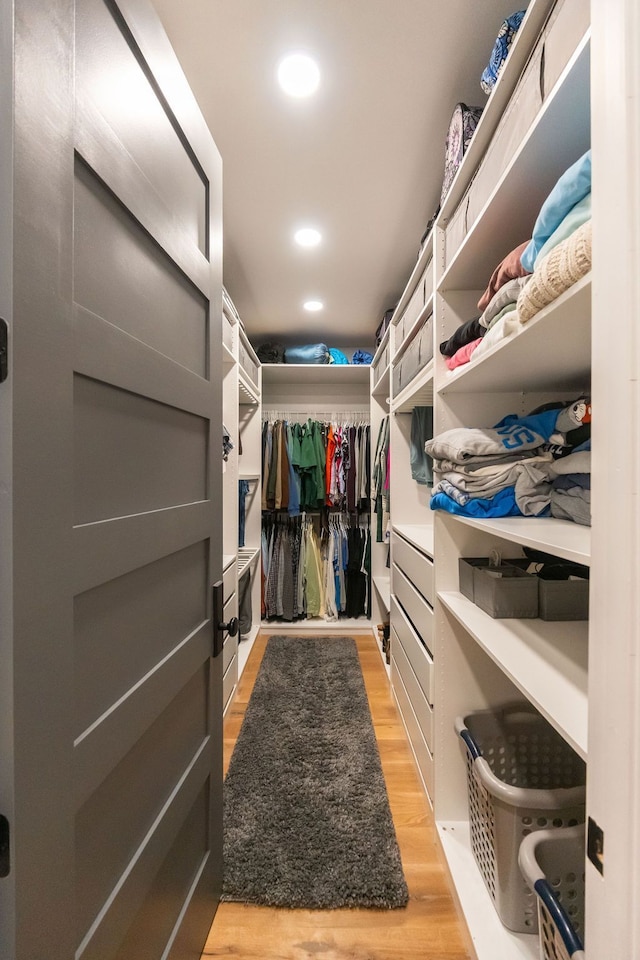 spacious closet with light hardwood / wood-style flooring