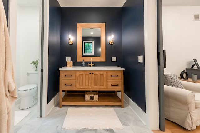 bathroom featuring vanity and toilet