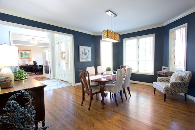 dining room with wood-type flooring, ceiling fan, and crown molding