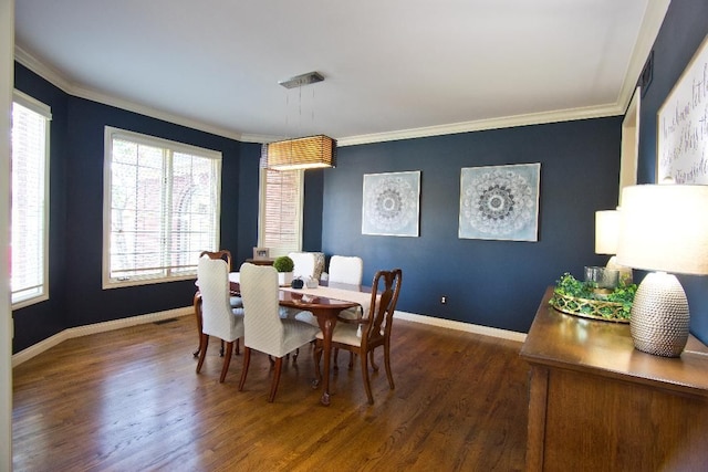 dining area featuring ornamental molding and dark wood-type flooring