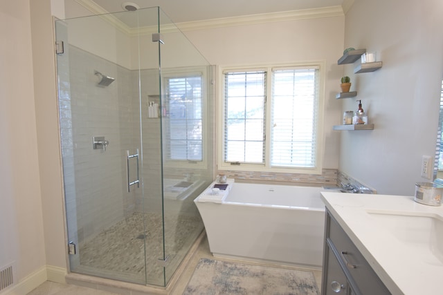 bathroom featuring tile patterned flooring, shower with separate bathtub, vanity, and ornamental molding