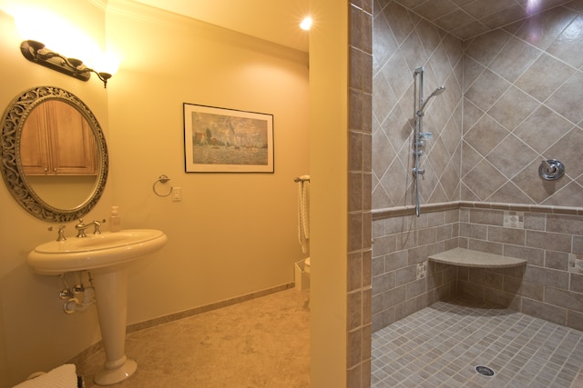 bathroom with a tile shower and ornamental molding