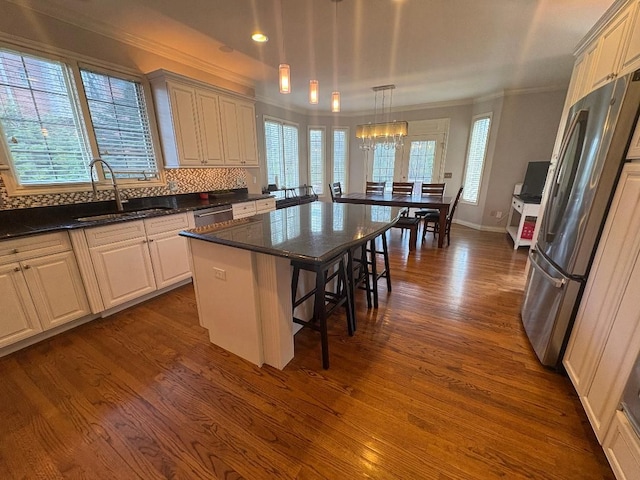 755 Majestic, Rochester Hills, MI 48306 - kitchen with a kitchen breakfast bar, crown molding, hanging light fixtures, a sink, and dark wood-type flooring