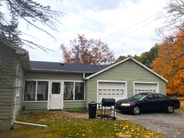 2399 S Cleveland Ave, Saint Joseph, MI 49085 - view of front of house with a garage and asphalt driveway