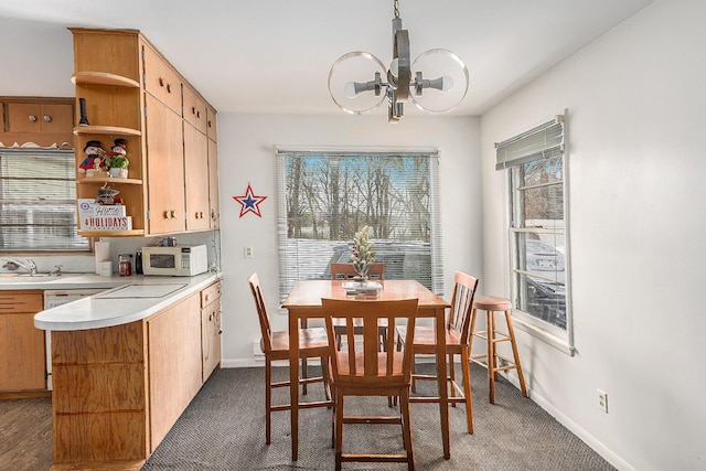 2399 S Cleveland Ave, Saint Joseph, MI 49085 - dining area featuring carpet floors, a chandelier, and baseboards