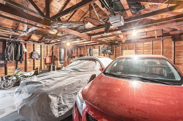 2399 S Cleveland Ave, Saint Joseph, MI 49085 - garage featuring a garage door opener and wood walls